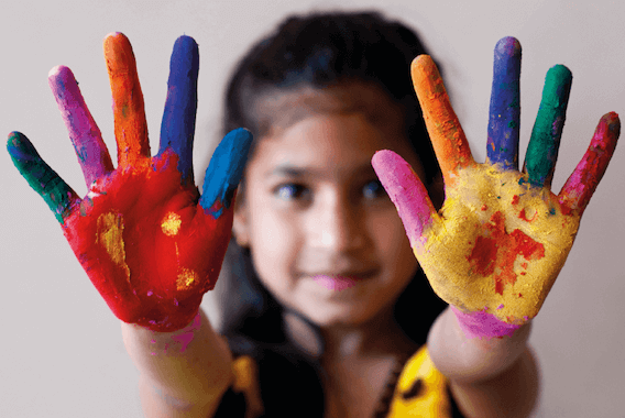 Child with rainbow painted hands